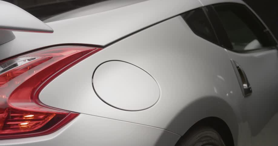 A silver car has a circular gas panel