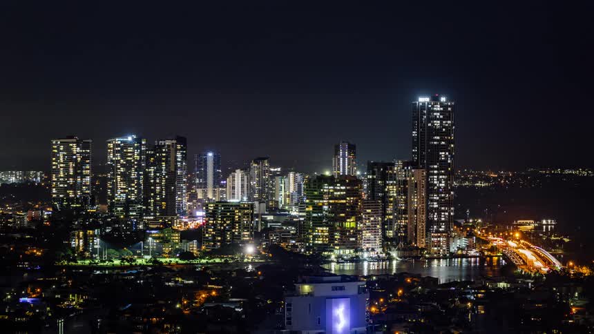 Time lapse view of a downtown city at night is displayed