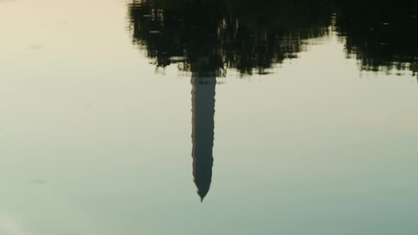 Water reflects washington monument and the sky
