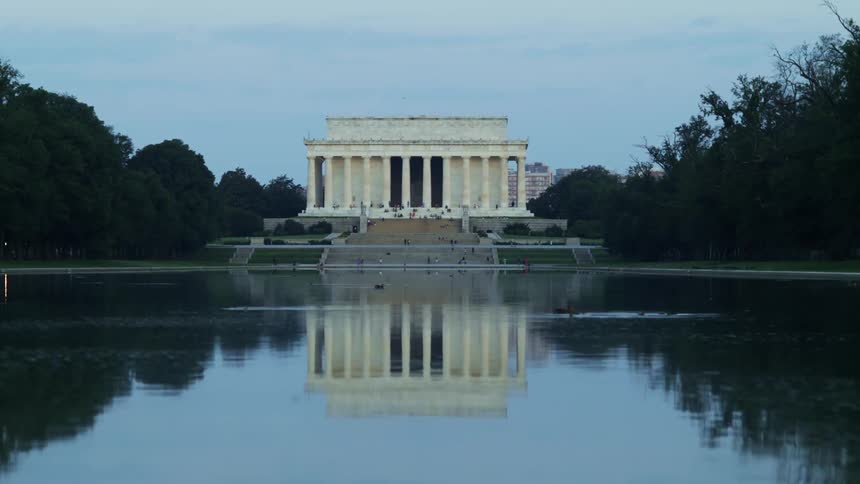 Ducks swim in the reflecting pool in front of the lincoln memorial
