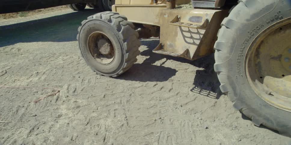 A tractor drives on a dirt road
