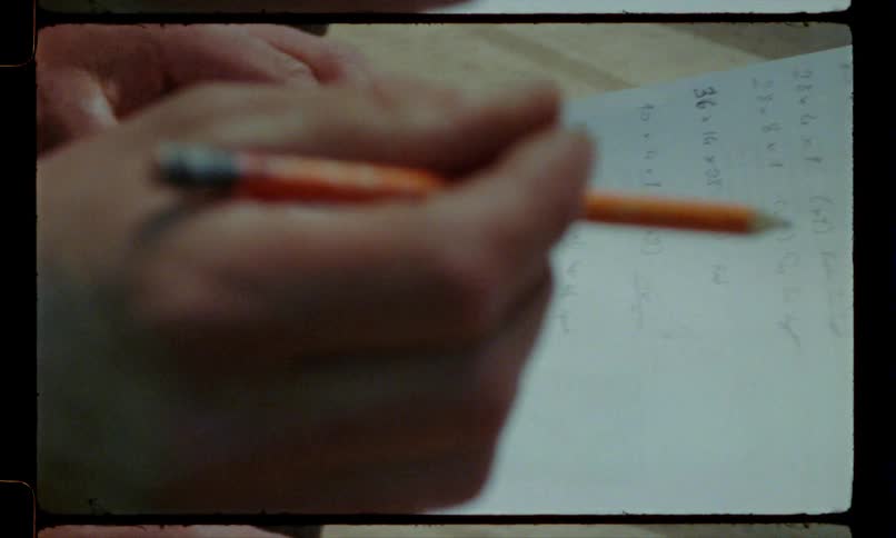 A teacher checks off homework problems on paper