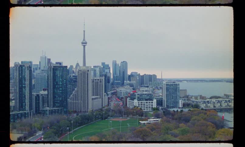 Big city along the coast with a tower standing tall above the buildings under a cloudy sky