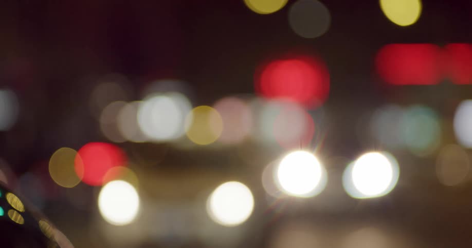 Lights from cars are blurred as they move