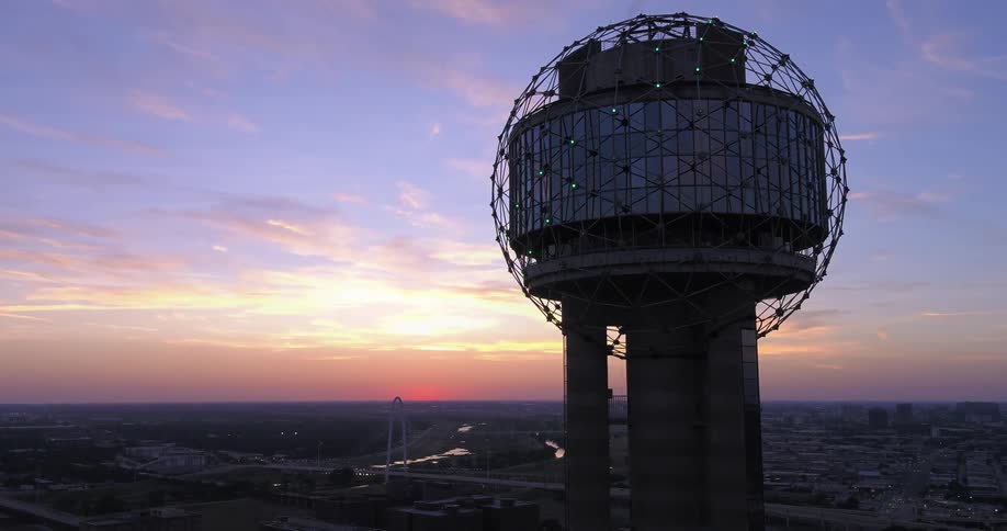 Dallas' famed Reunion Tower sparkles in front of Margaret Hunt Hill Bridge in downtown Dallas, Texas, at sunset