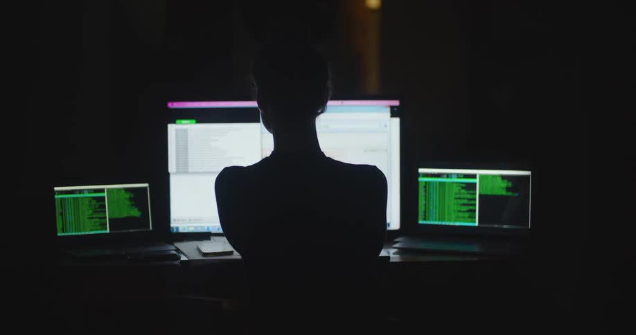 A young woman is working with some computers