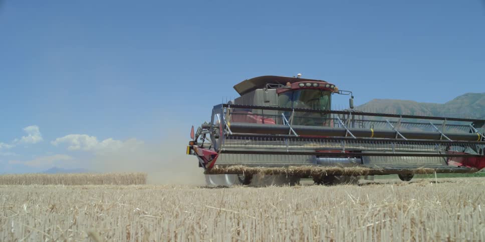 Farm equipment scraping a field