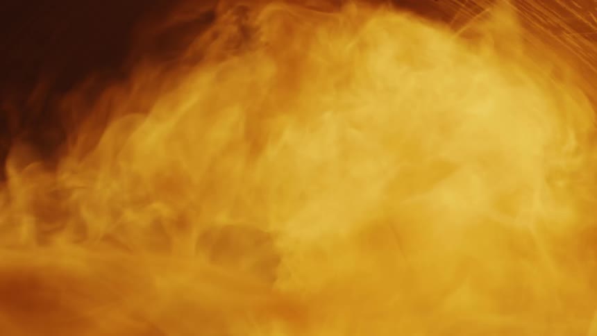 Bright flames flare up then die inside an oven furnace
