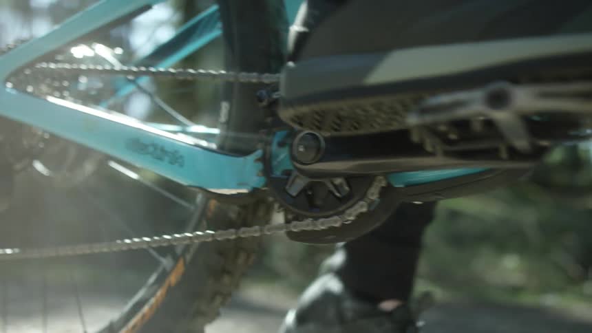 A person pushes on a bike pedal and starts to cycle