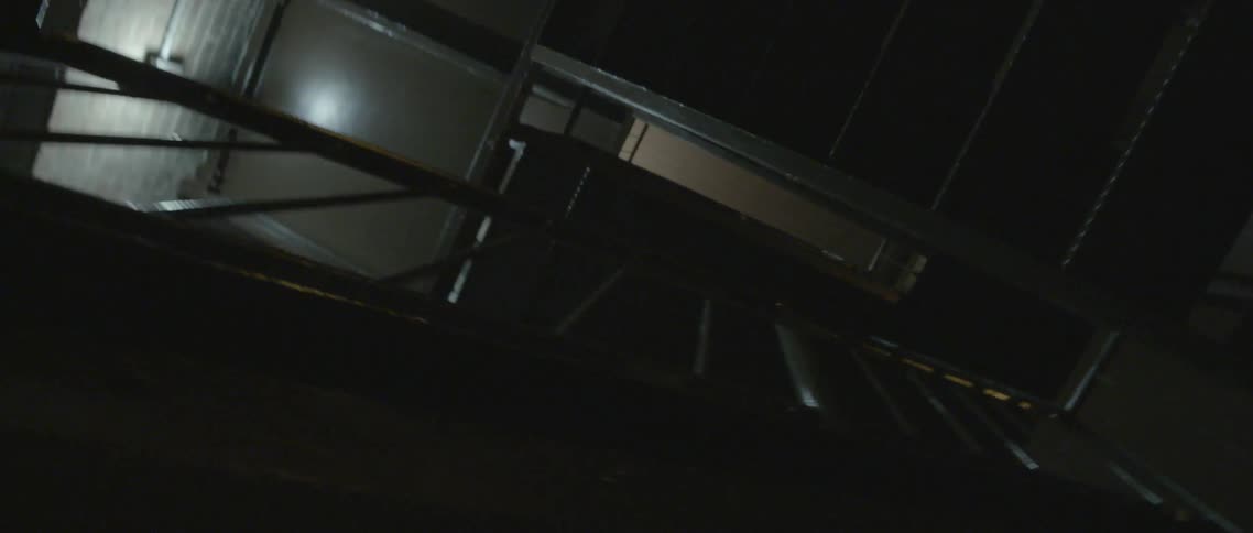 Moving up some steps in a dark staircase