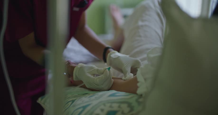 Female nurse uses cotton swab to dab up blood after giving patient and injection