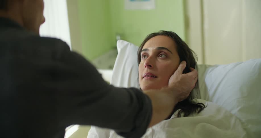 A woman lying in a hospital bed