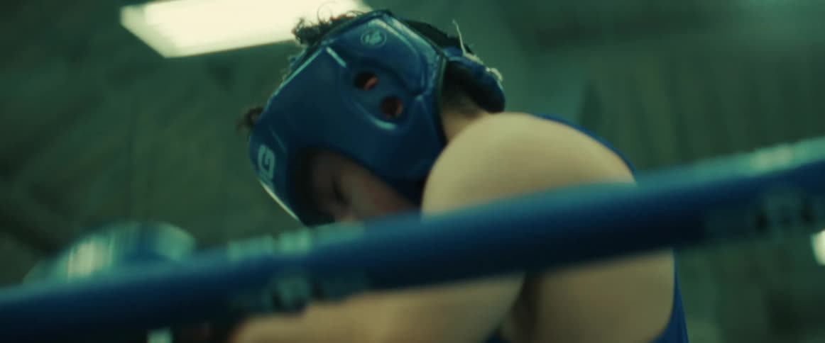 A young hispanic man prepares for a boxing match inside the ring