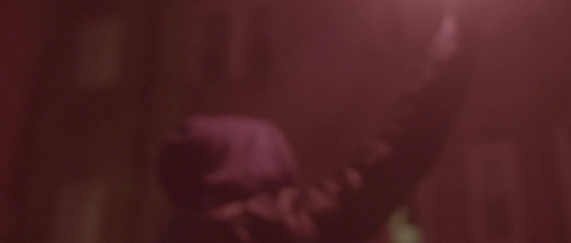 A man holds a flare in the air