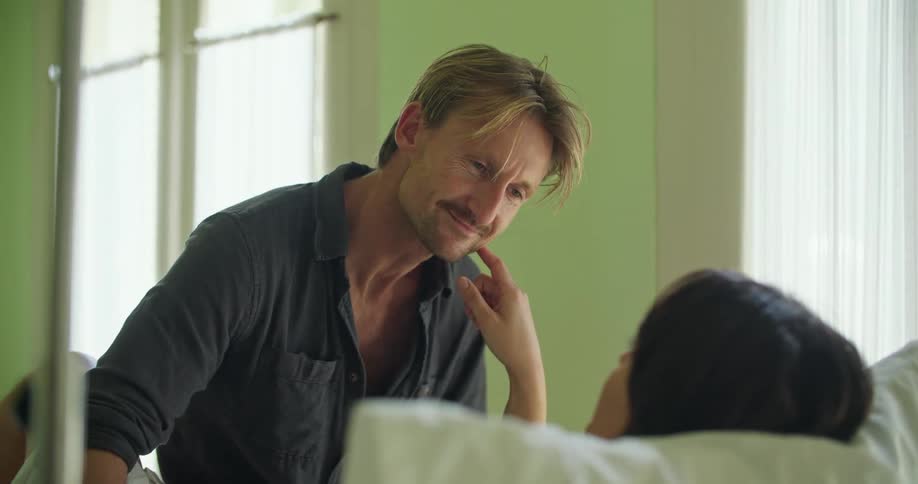 A young couple is at the hospital room in the middle of the day