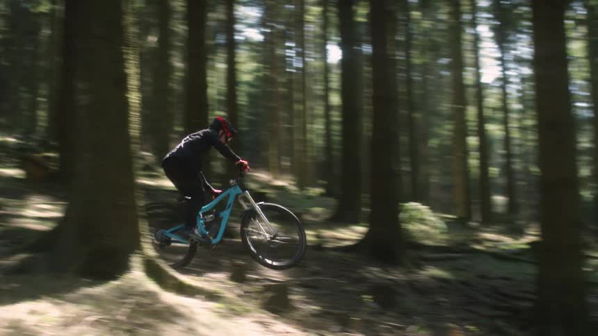 A man is riding his mountain bike down the hill