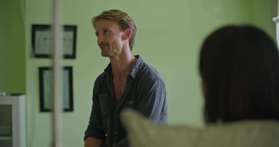 Two people are at the hospital talking to each other