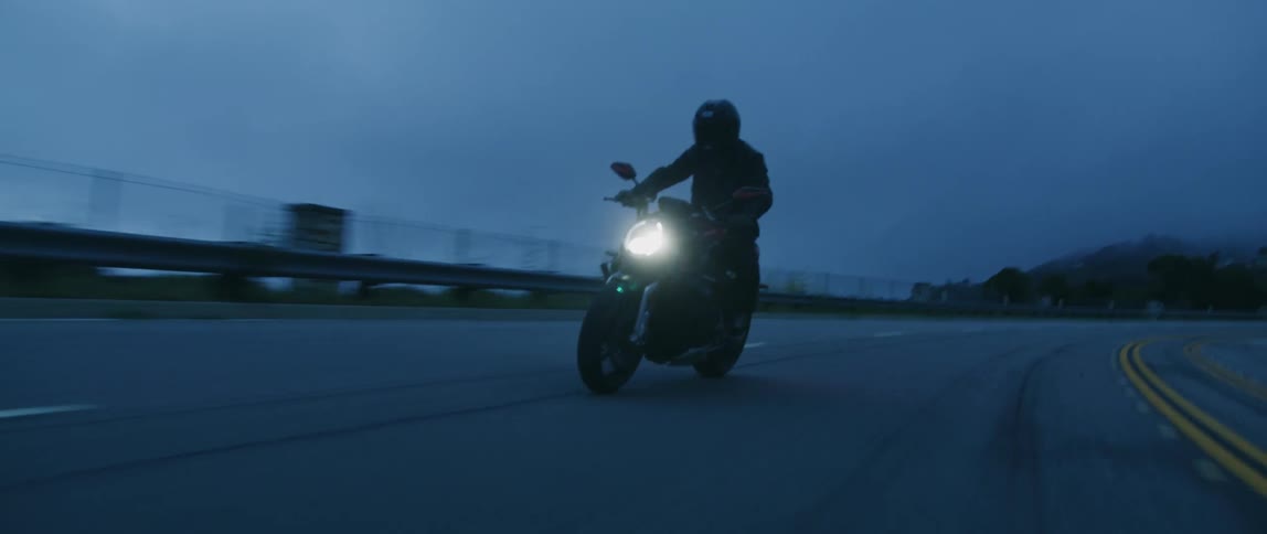 The motorcycle travels on the road