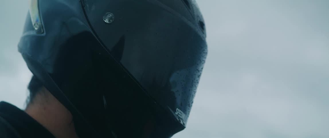 A young white man is riding there motorcycle in the middle of the day time