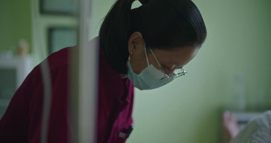 A nurse inserts an iv into a patients arm