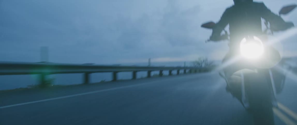 A man swerves as he rides a motorcycle