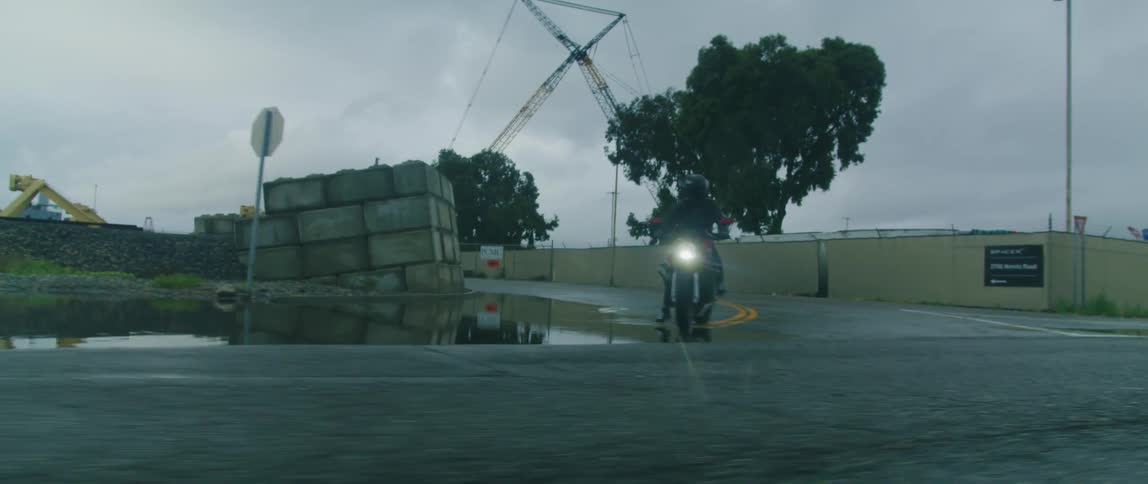 A man is on his motorcycle on the road