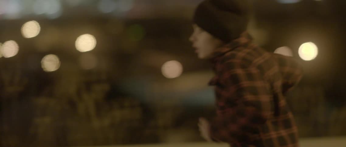 A boy runs down a highway