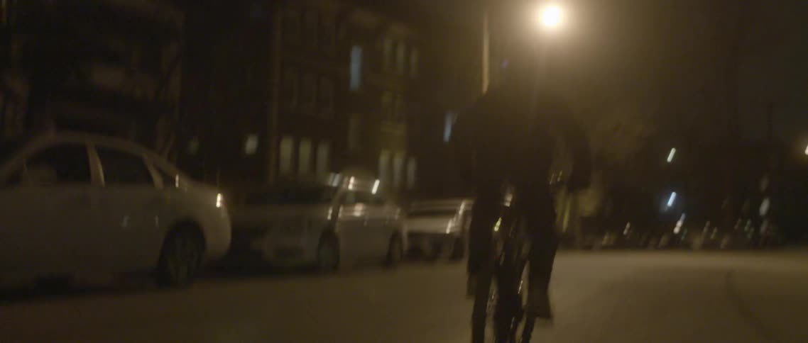 A boy rides his bike in the street