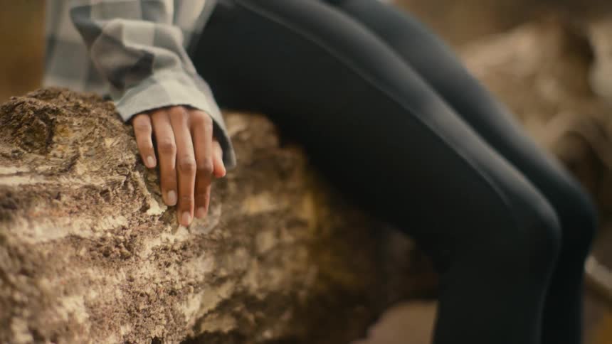 A woman is sitting on the branch
