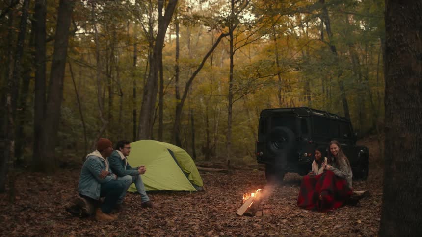 People are sitting around the campfire
