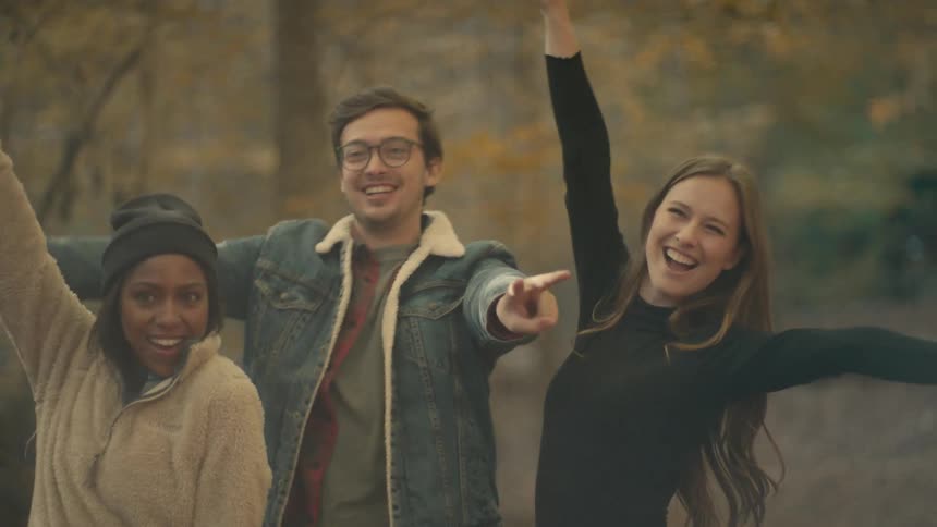 People pose for a picture in the woods