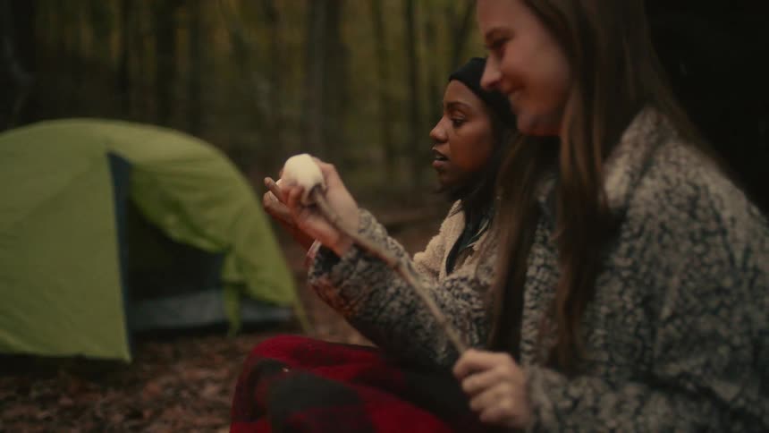 There are friends that are camping with each other in the forest
