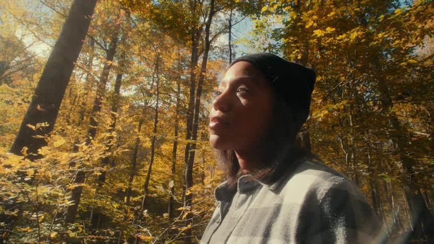 A woman standing out in a forest