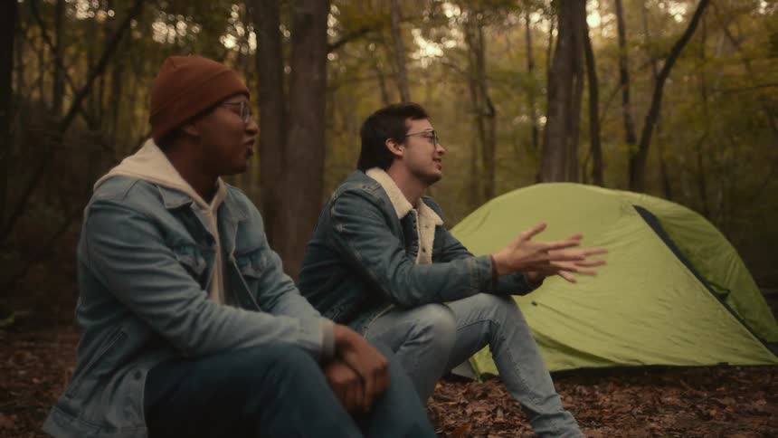 Two friends are talking and are camping together
