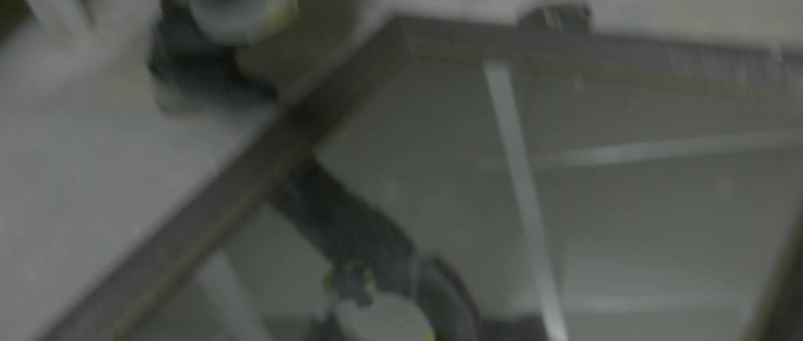 A teenager violently break a mirror that is on a floor