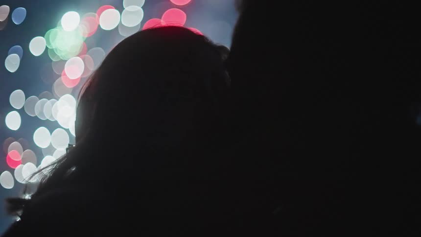 A couple kiss as the fireworks go off