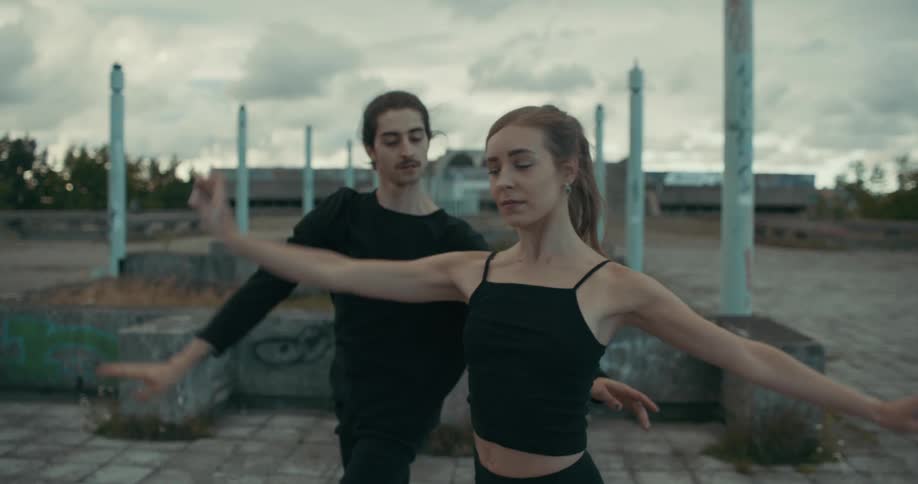 A man and woman dancing outdoors