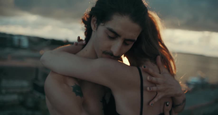 A man and woman embrace as they dance