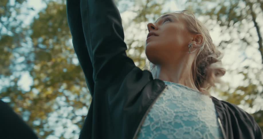 A male and female ballet dancer practice together in the woods