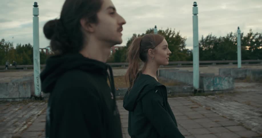 A man and woman walking outdoors
