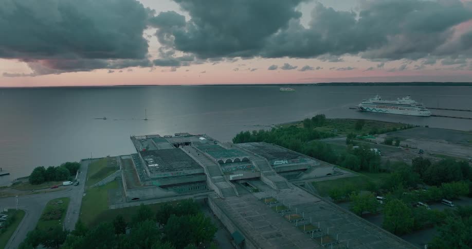 An aerial view of a the coast with a ship in the water
