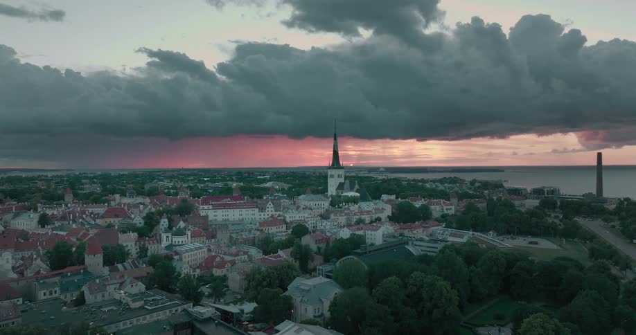 Dark storm clouds over building in a city on the shore