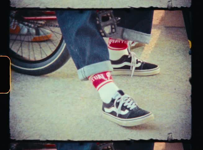 A person sits on a bicycle outside