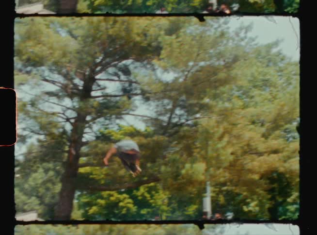 A man does a jump on his skateboard