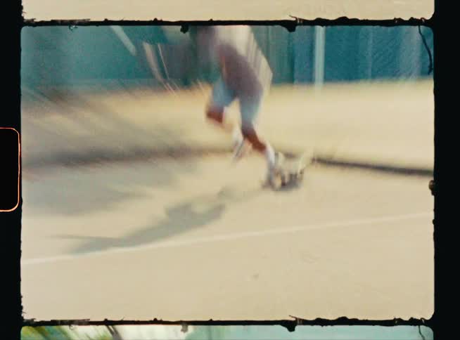 A man falls off his skateboard while attempting a small jump