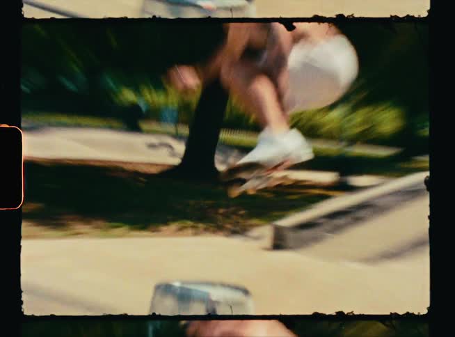 A skateboarder jumps onto the flat surface of a ramp