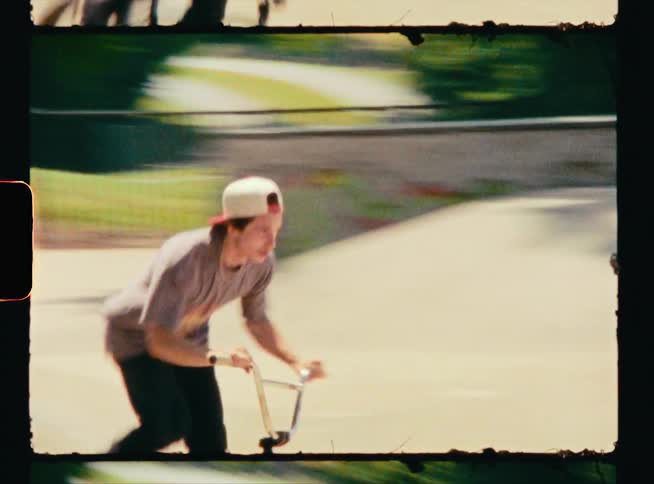 A teenager is biking at a park during spring