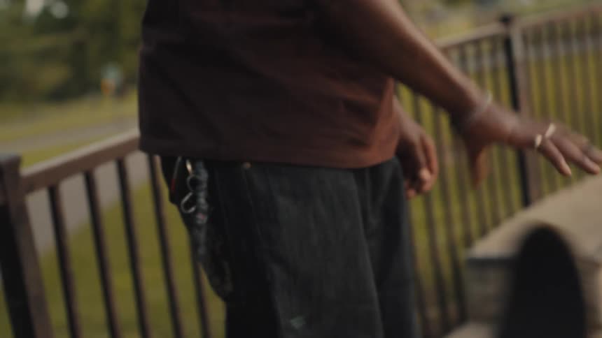 A man is outdoors with his skateboard in spring
