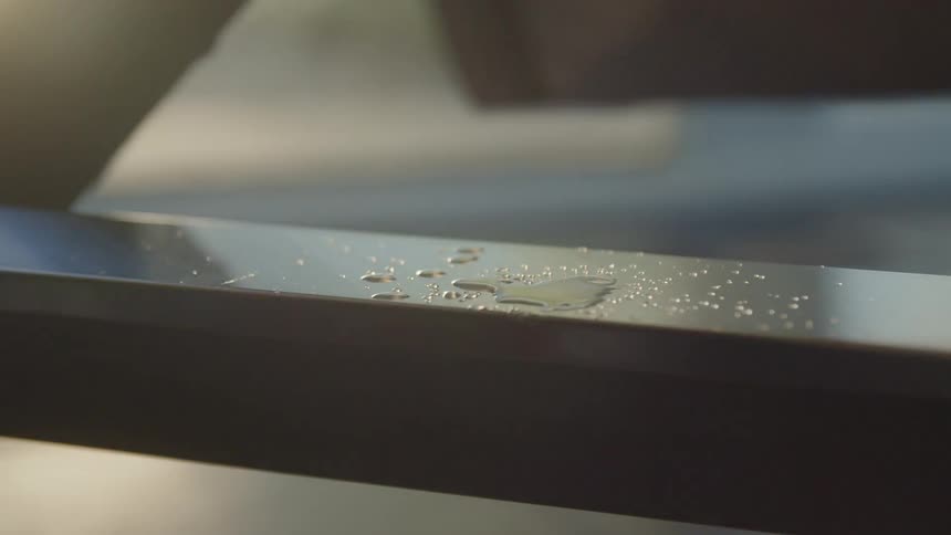 Sweat drips down onto a rowing machine bar as a person works out