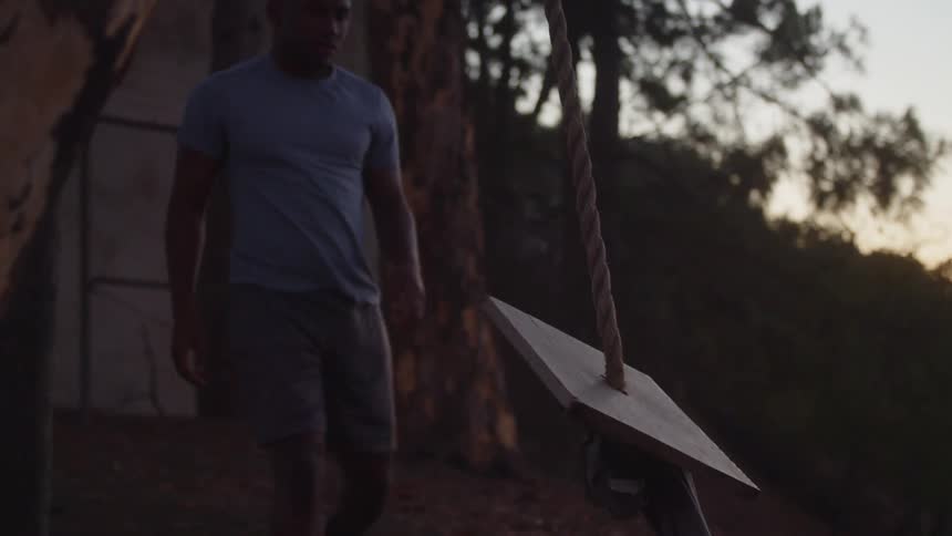 A young black man is outside around the nature area